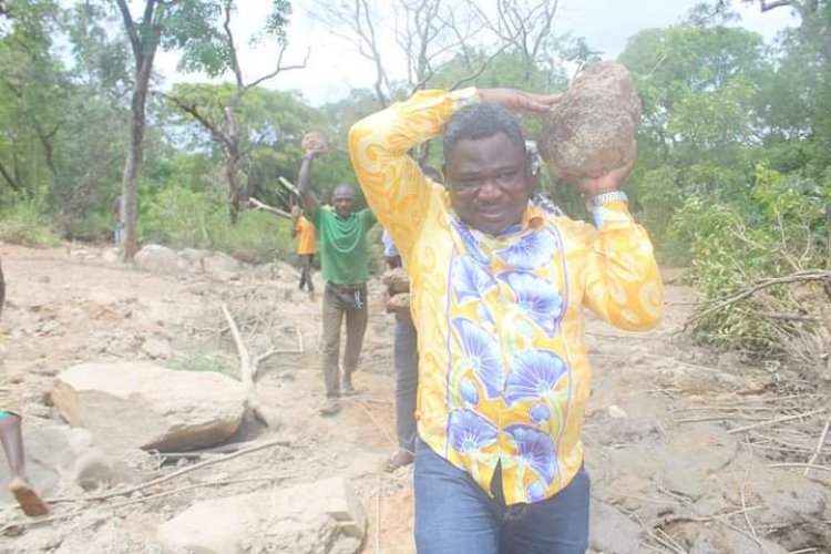 MP and constituents carry Stones to fix deplorable road