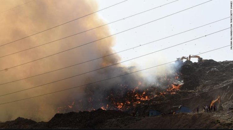 As poisonous gases fill the air, Indian firemen battle a landfill fire in Delhi.