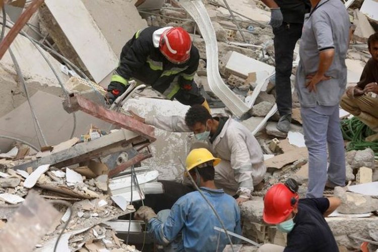 Two young boys were discovered hugging amid the rubble after they were killed in a building collapse.