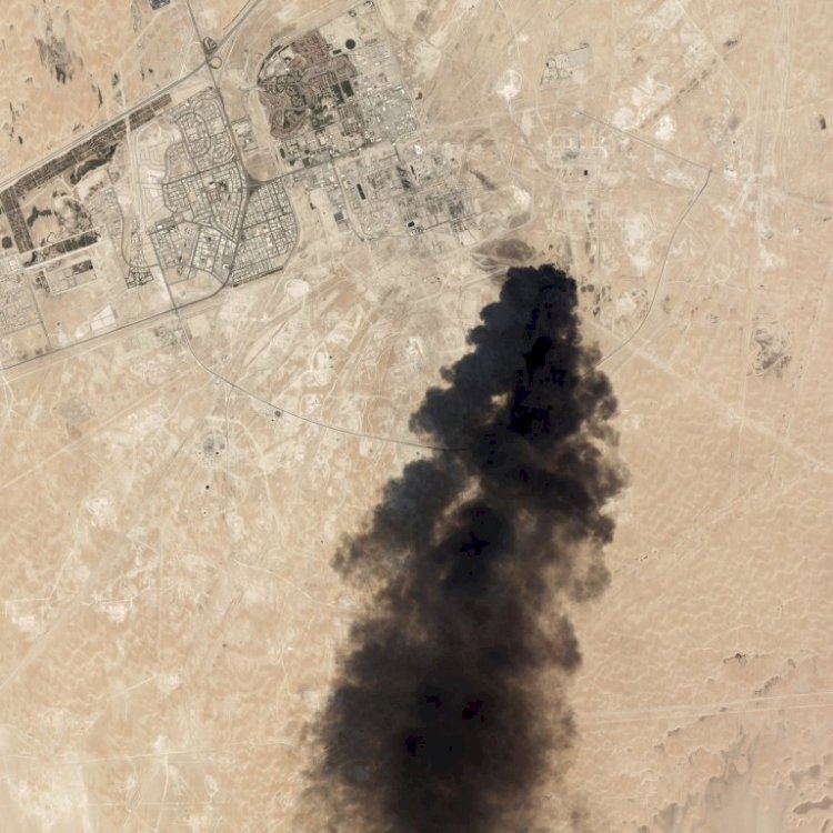 A huge plume of smoke rises from the oil field that was struck by drones