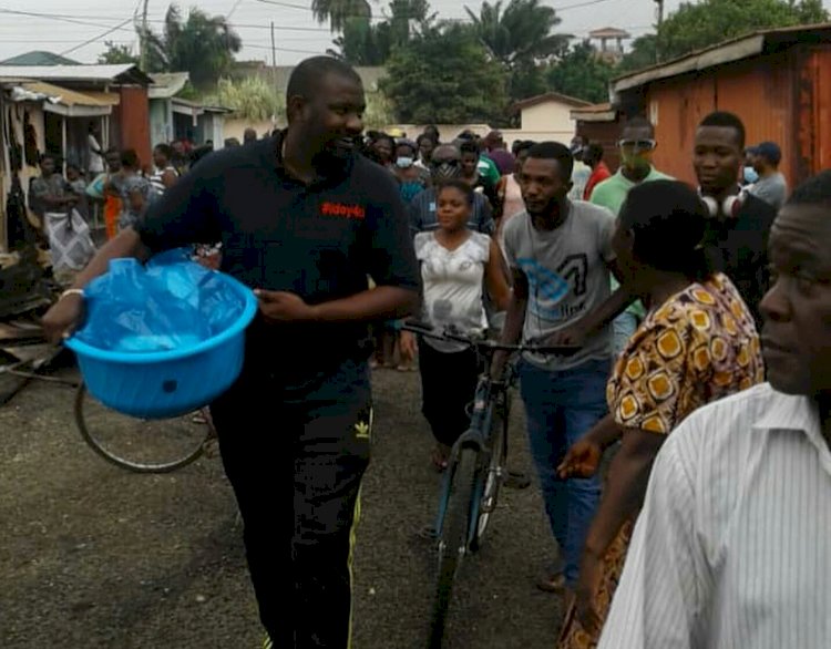 NDC Hopeful, John Dumelo feeds Shiashie residents affected by the fire outbreak